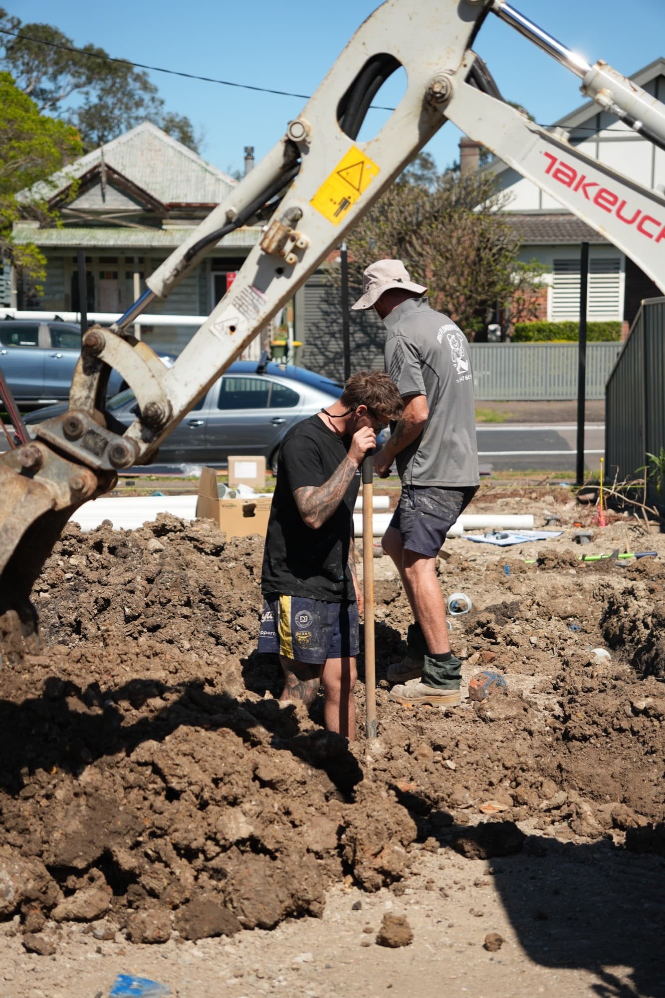 Zimco Plumbing crew digging drainage on a Newcastle site